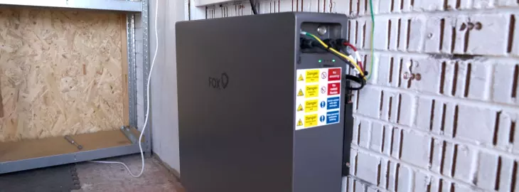 Installed solar battery storage unit with safety labels in utility area