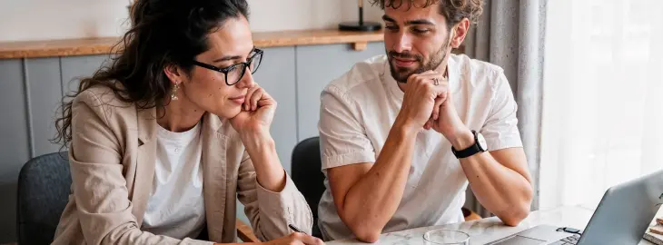 Couple reviewing home energy or solar installation paperwork together