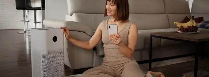 Portable air conditioning unit in a modern home being operated via smartphone