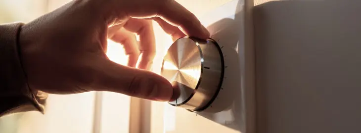 Hand adjusting manual room thermostat dial