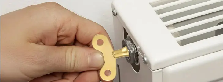 Radiator bleed key inserted into bleed valve